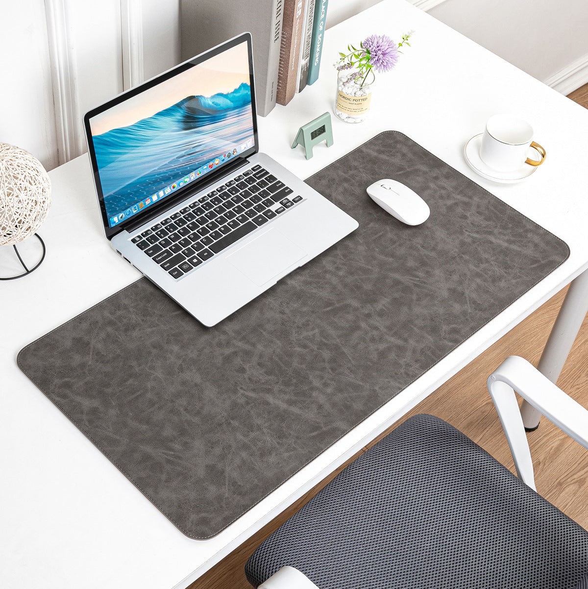 NOIRDEN premium gray leather desk mat styled with laptop and mouse on a minimal white desk
